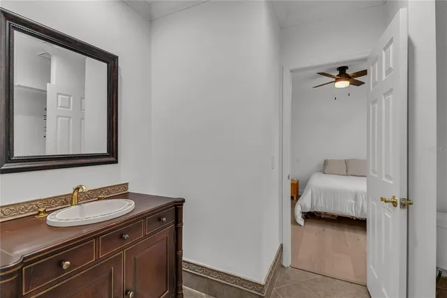 a bathroom with a granite countertop sink a light fixture and a mirror
