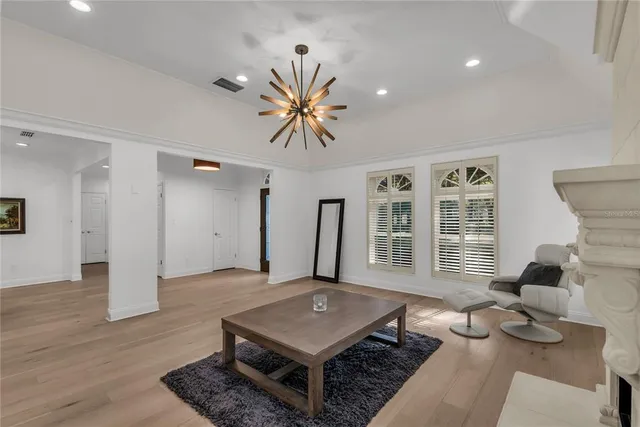 a living room with furniture pool table and a window