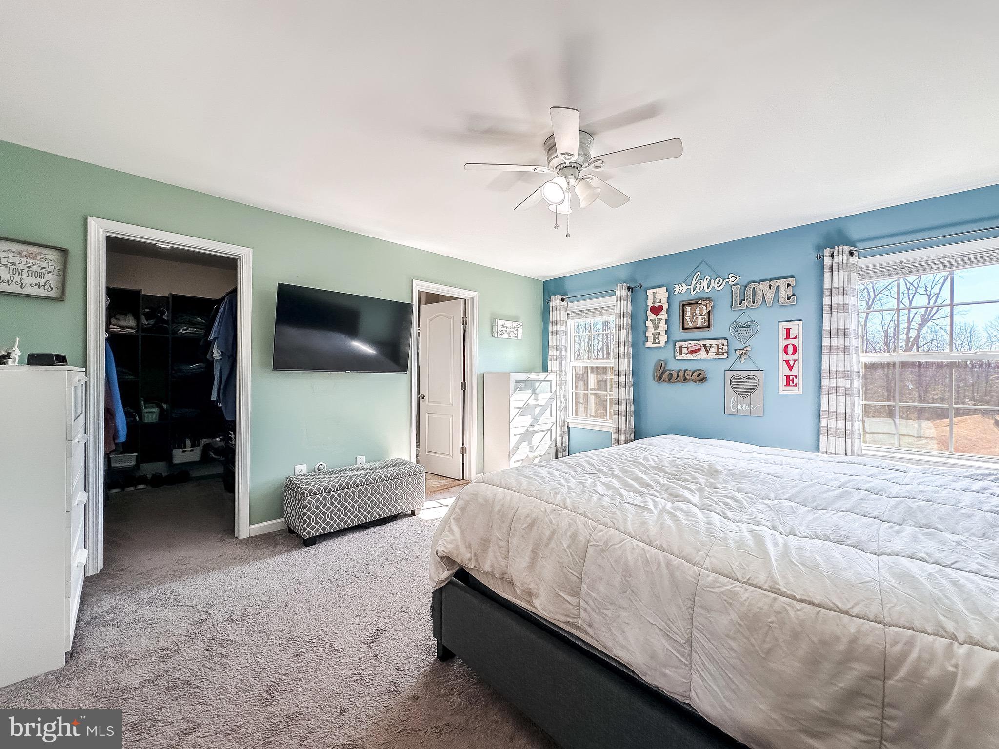 10503 Braddock Run Road Baltimore, MD 21220 - Photo 27 of 64 a bedroom with a large bed and a flat tv screen