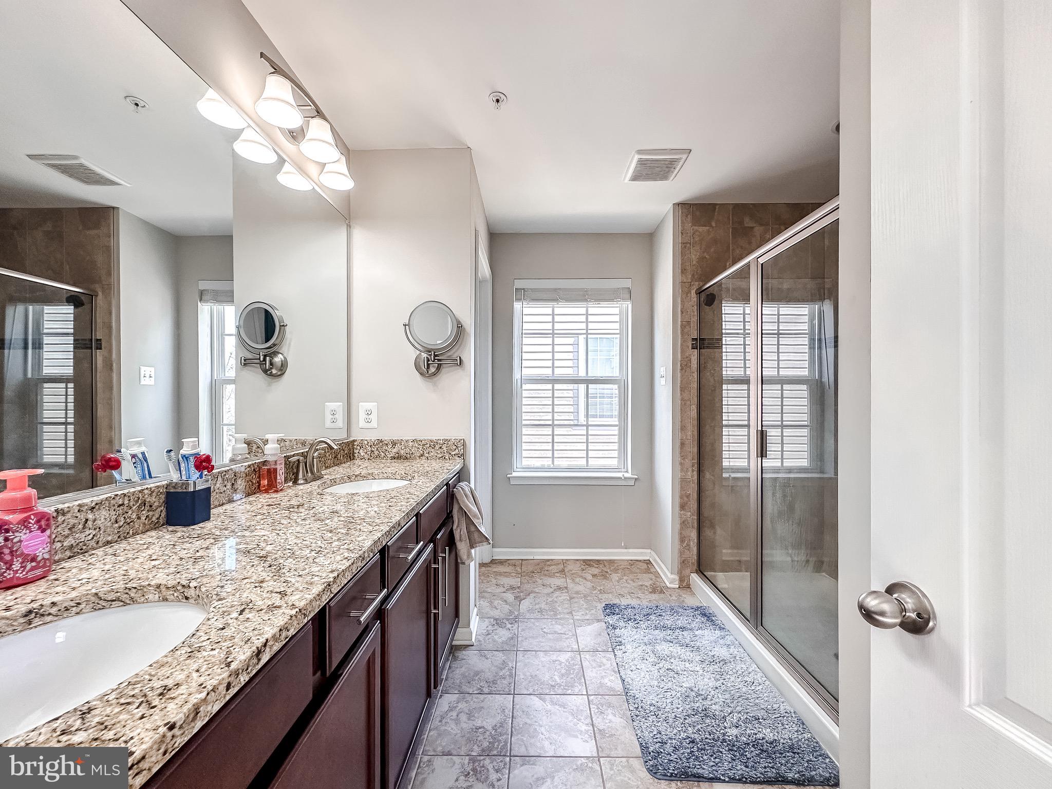 10503 Braddock Run Road Baltimore, MD 21220 - Photo 30 of 64 a bathroom with a granite countertop sink and a mirror