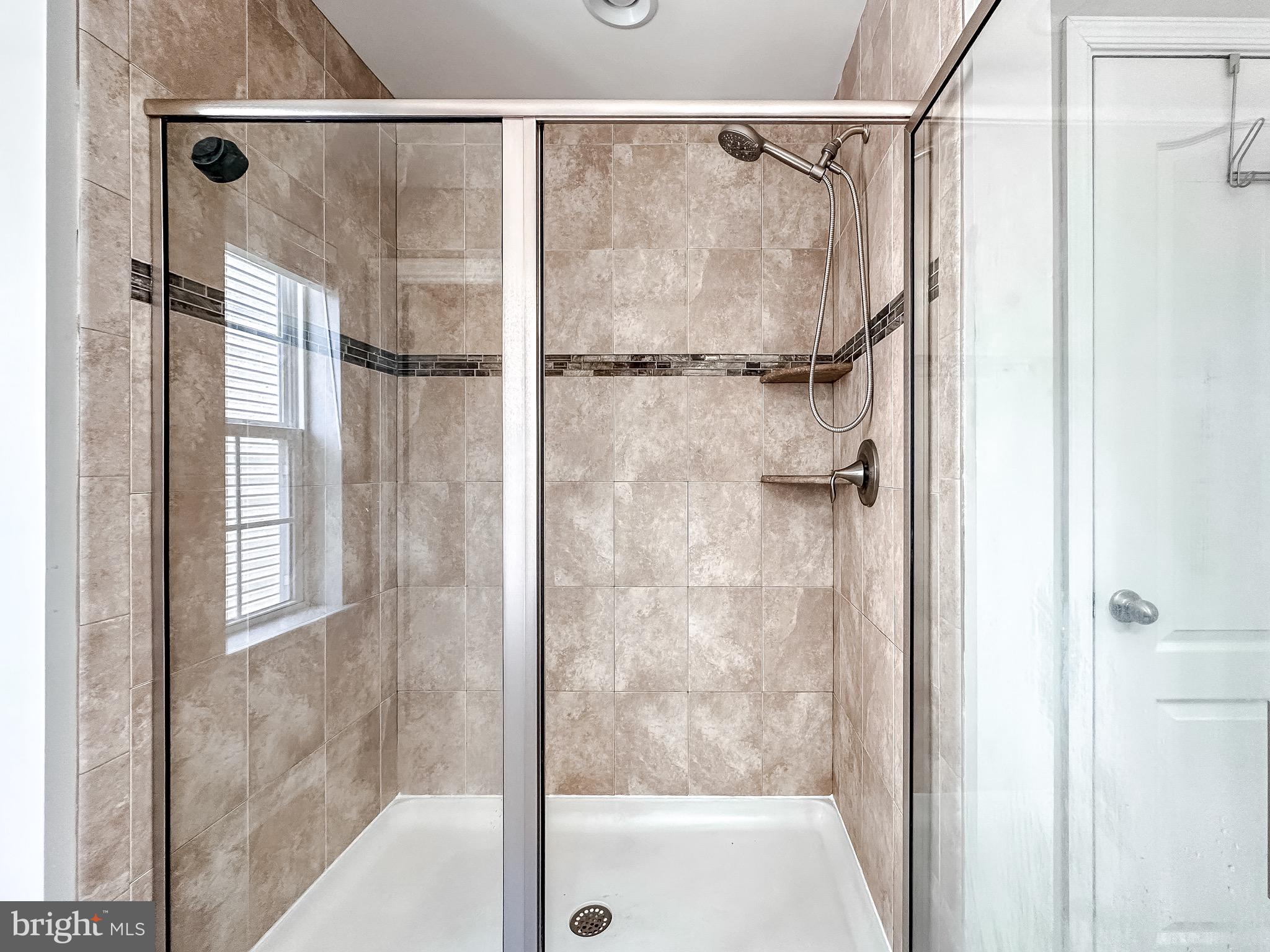 10503 Braddock Run Road Baltimore, MD 21220 - Photo 31 of 64 a bathroom with a glass shower door