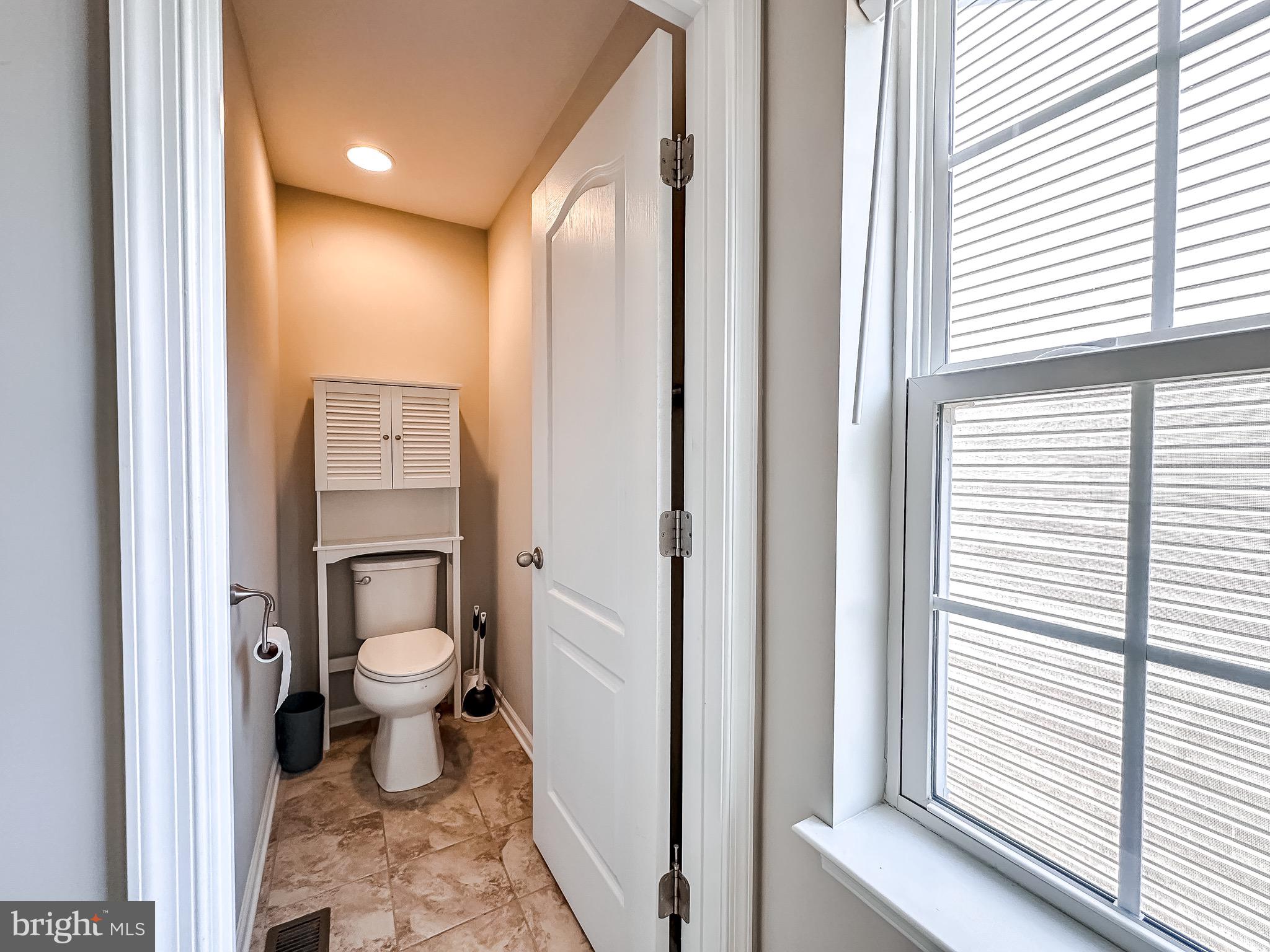 10503 Braddock Run Road Baltimore, MD 21220 - Photo 33 of 64 a bathroom with a toilet sink and a window