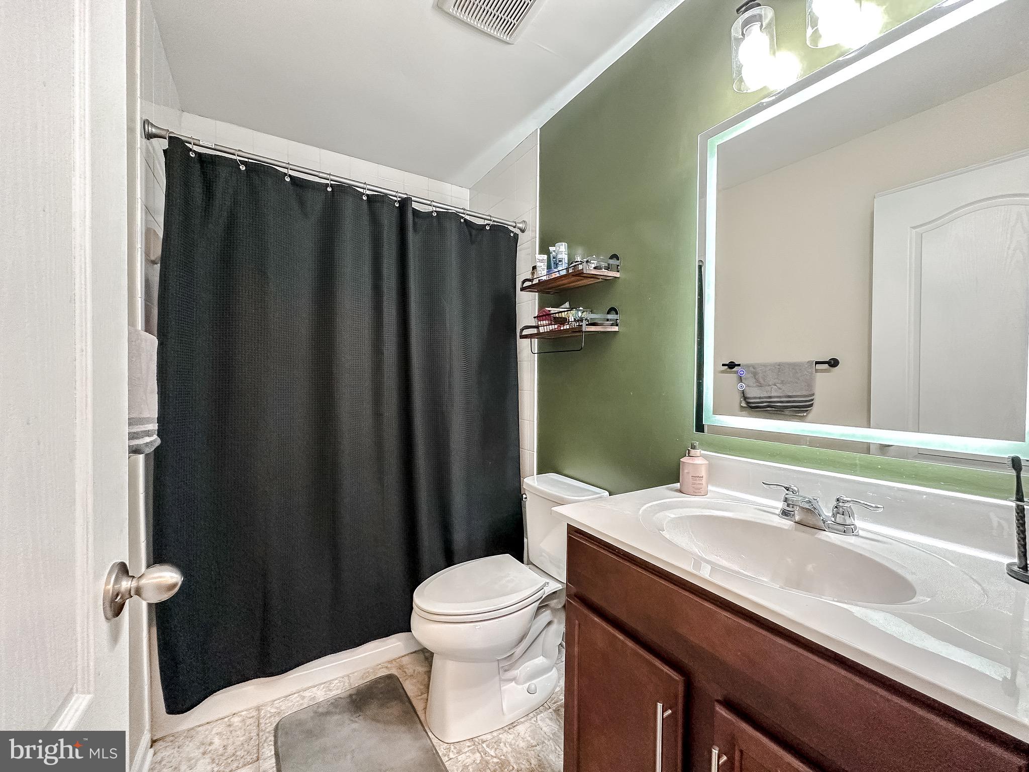 10503 Braddock Run Road Baltimore, MD 21220 - Photo 45 of 64 a bathroom with a granite countertop sink toilet and shower