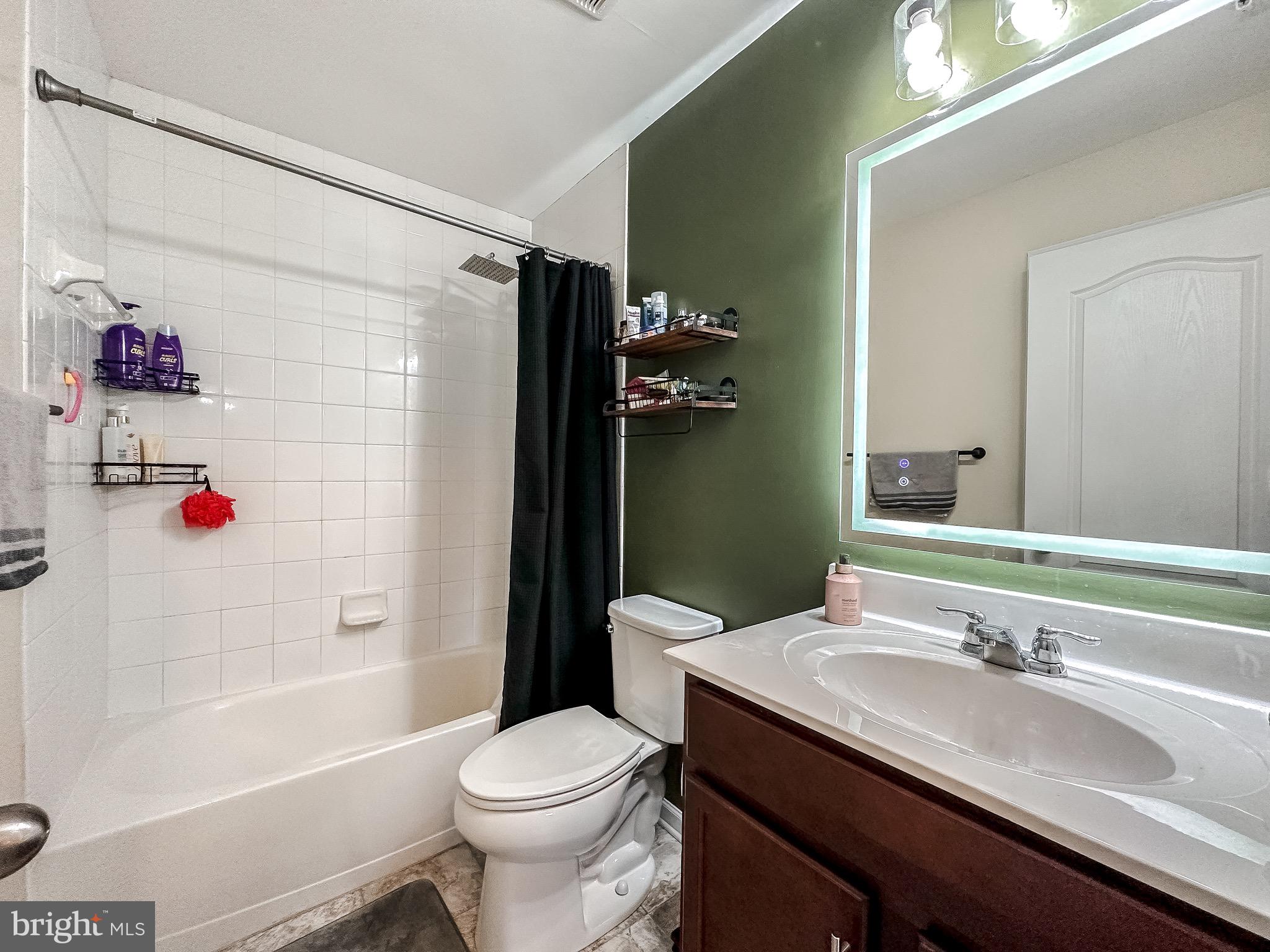 10503 Braddock Run Road Baltimore, MD 21220 - Photo 46 of 64 a bathroom with a granite countertop sink toilet and shower