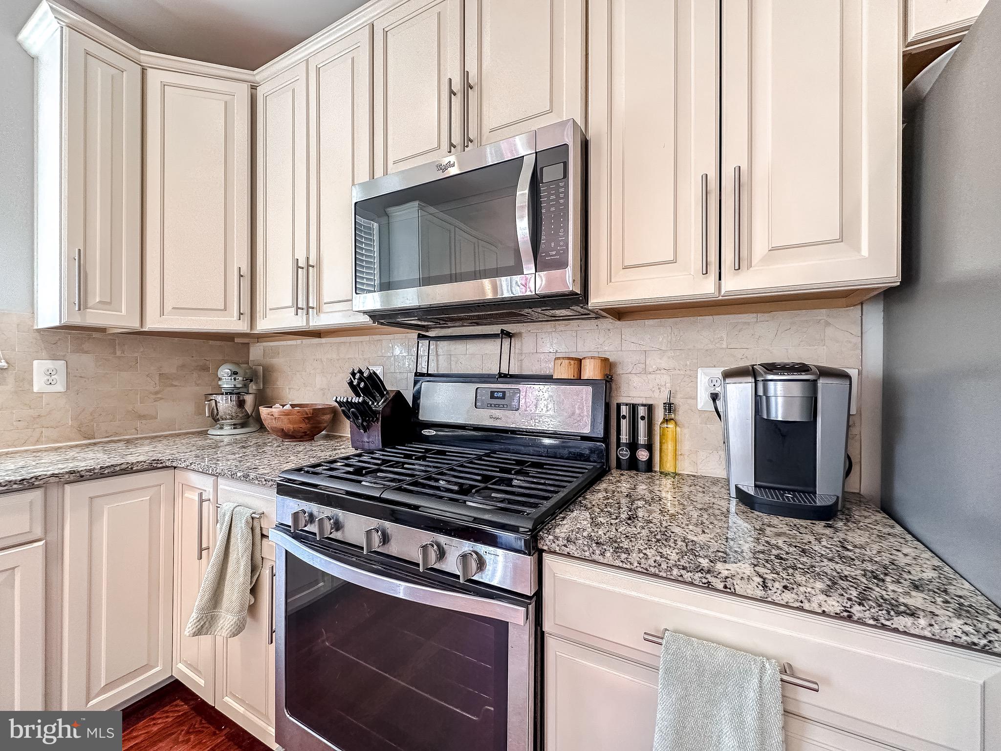 10503 Braddock Run Road Baltimore, MD 21220 - Photo 10 of 64 a kitchen with stainless steel appliances granite countertop a stove a microwave and cabinets