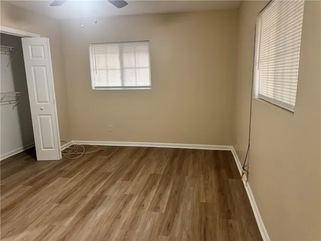a view of a room with wooden floor and window