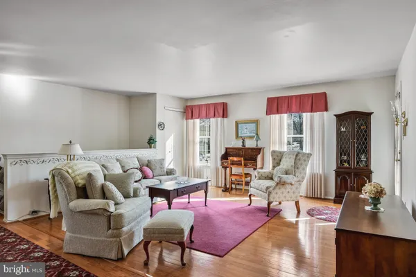 a living room with furniture rug and lamp