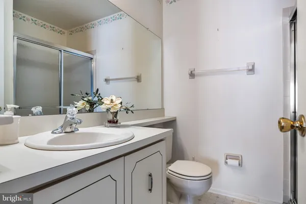 a bathroom with a sink toilet and a mirror