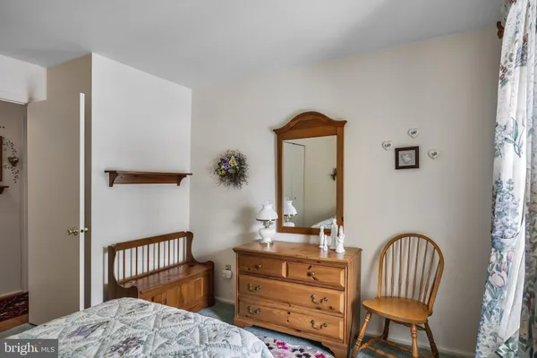 a bedroom with furniture and a window