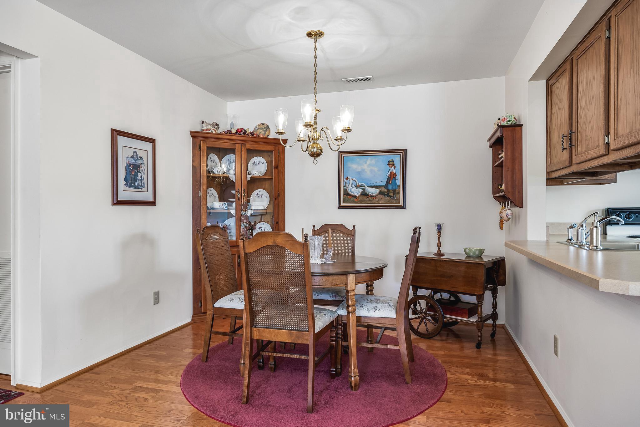 3522B Neils Court Mount Laurel, NJ 08054 - Photo 5 of 25 a view of a dining room with furniture a chandelier and wooden floor