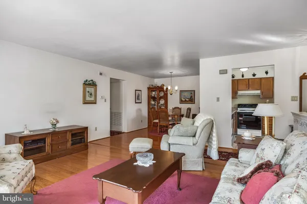 a living room with furniture a rug and a lamp