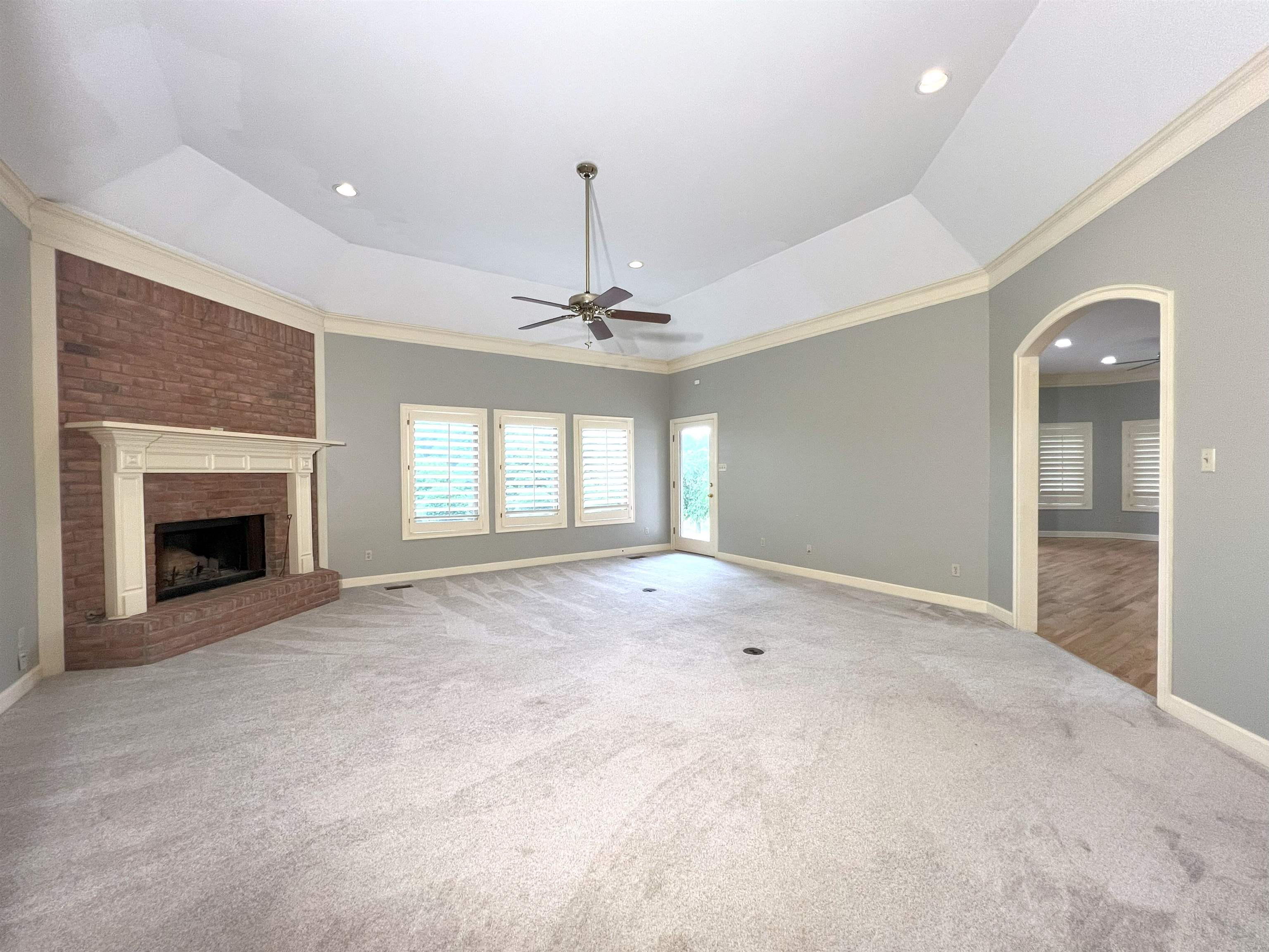 2055 Bobbitt Road Williston, TN 38076 - Photo 15 of 40 Unfurnished living room featuring carpet floors, a ceiling fan, baseboards, and crown molding