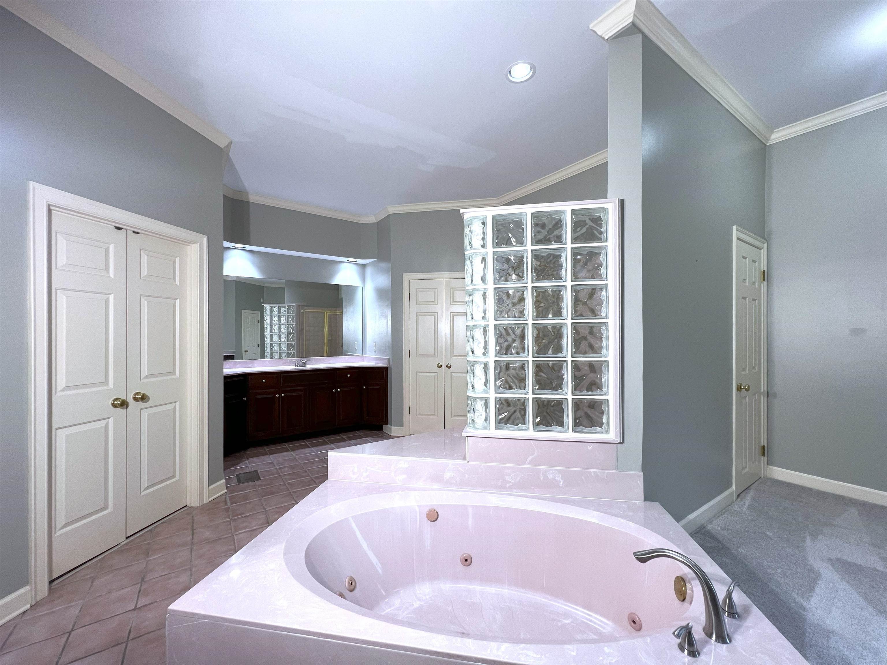 2055 Bobbitt Road Williston, TN 38076 - Photo 19 of 40 Bathroom featuring a whirlpool tub, ornamental molding, baseboards, and vanity