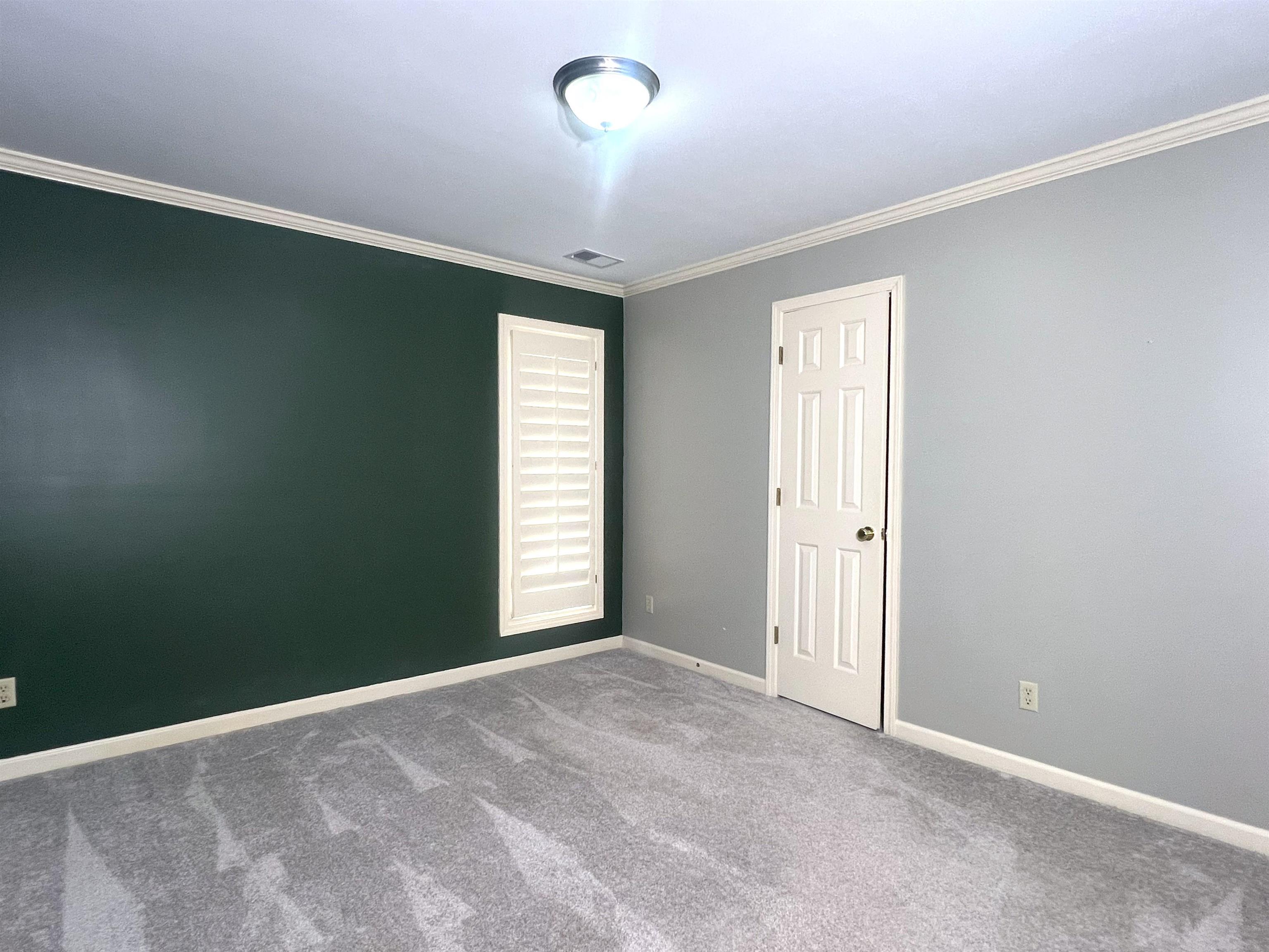 2055 Bobbitt Road Williston, TN 38076 - Photo 25 of 40 Carpeted empty room with baseboards, visible vents, and ornamental molding