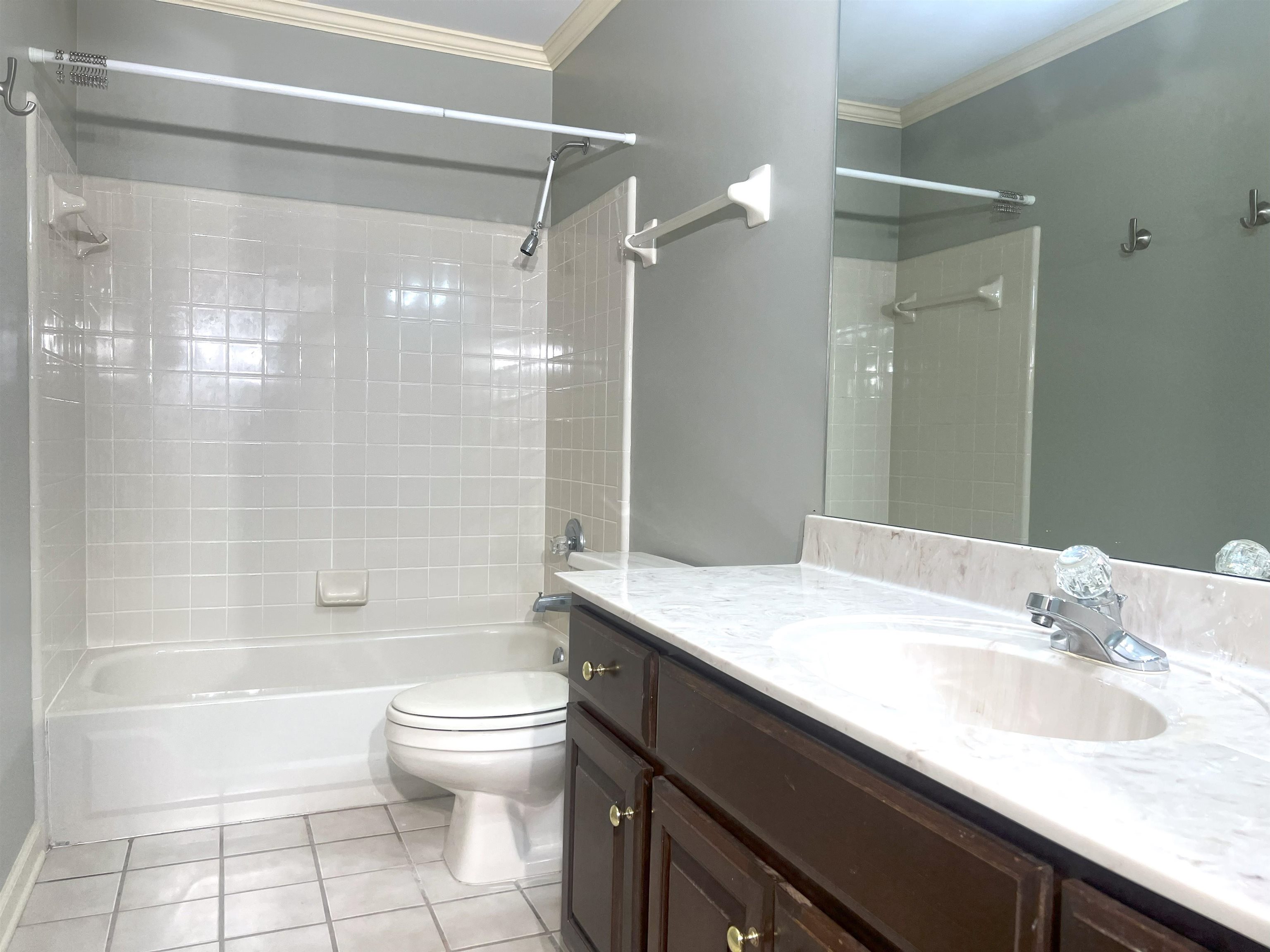 2055 Bobbitt Road Williston, TN 38076 - Photo 26 of 40 Bathroom featuring crown molding, tile patterned flooring, vanity, shower / bathtub combination, and toilet