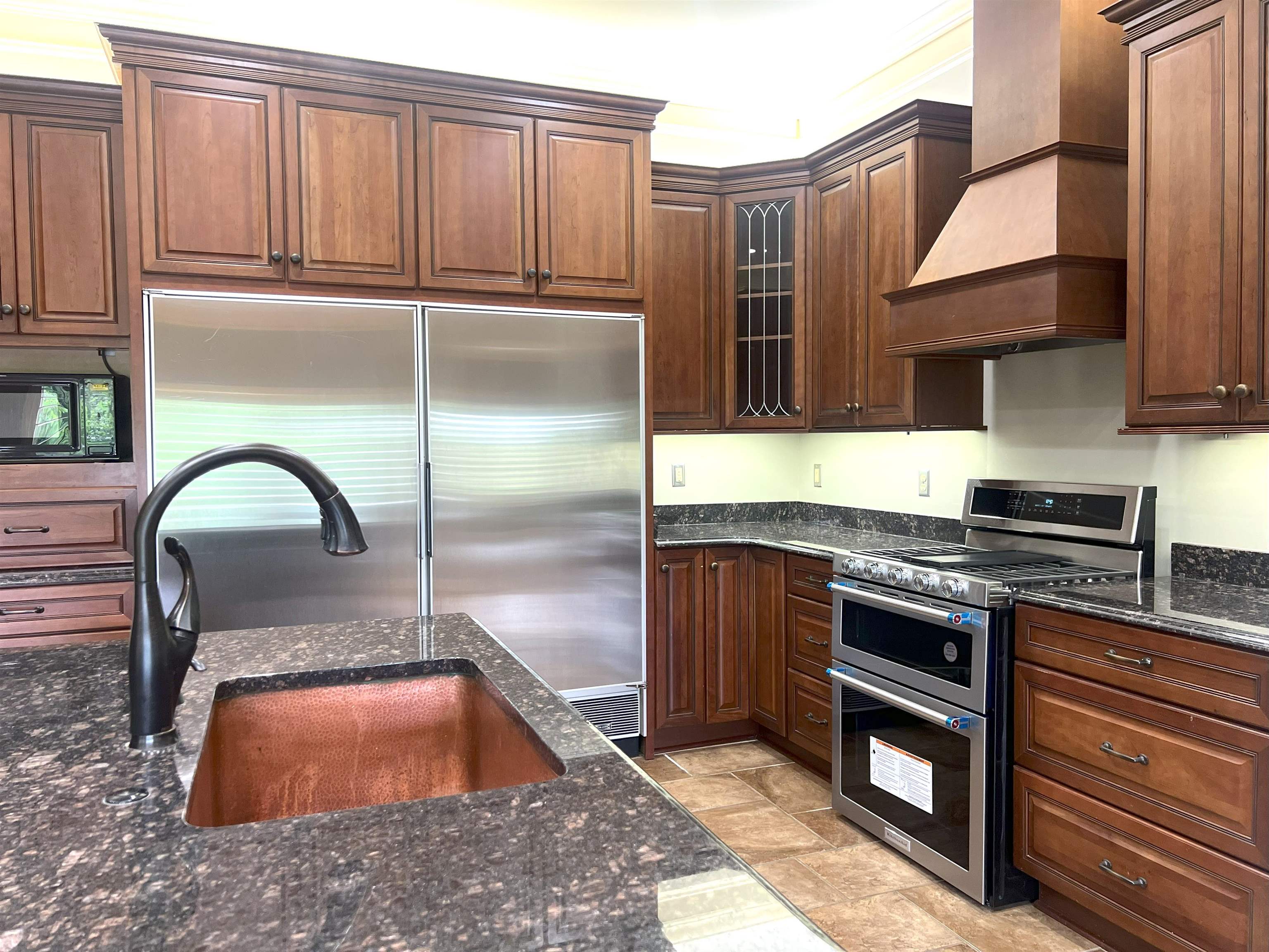 2055 Bobbitt Road Williston, TN 38076 - Photo 3 of 40 Kitchen featuring stone finish floor, dark stone counters, custom range hood, a sink, and appliances with stainless steel finishes