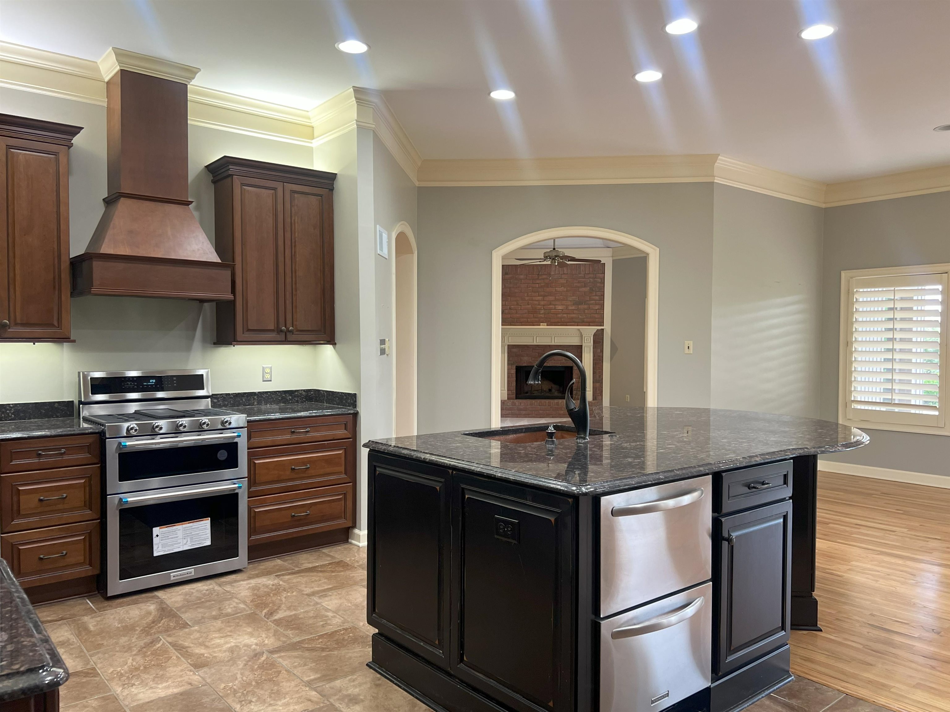 2055 Bobbitt Road Williston, TN 38076 - Photo 6 of 40 Kitchen featuring custom exhaust hood, a fireplace, arched walkways, a sink, and stainless steel appliances