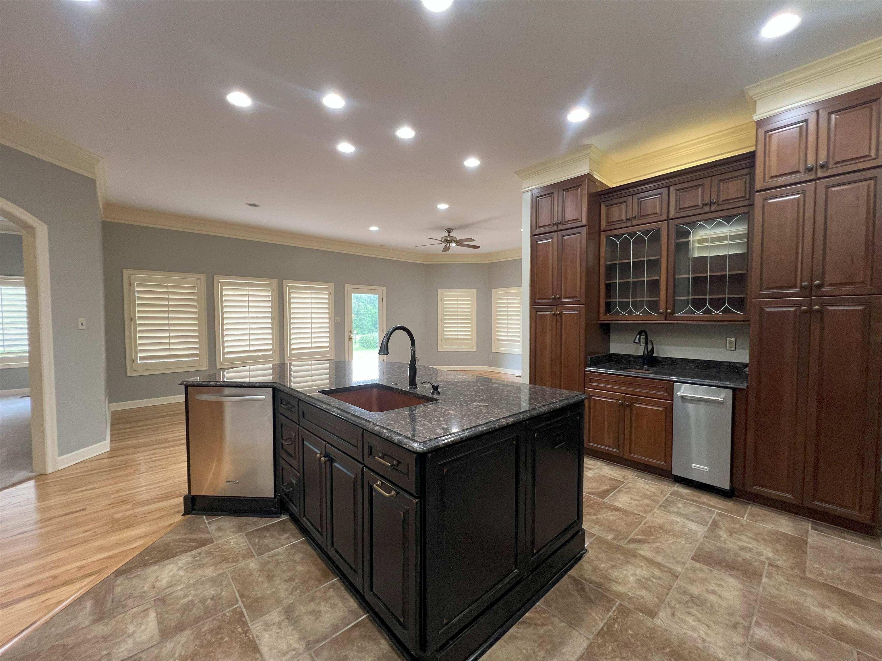 2055 Bobbitt Road Williston, TN 38076 - Photo 7 of 40 Kitchen with a sink, dishwasher, ornamental molding, baseboards, and a center island with sink