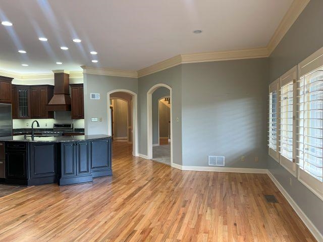 2055 Bobbitt Road Williston, TN 38076 - Photo 9 of 40 Kitchen featuring visible vents, custom exhaust hood, dark countertops, arched walkways, and appliances with stainless steel finishes