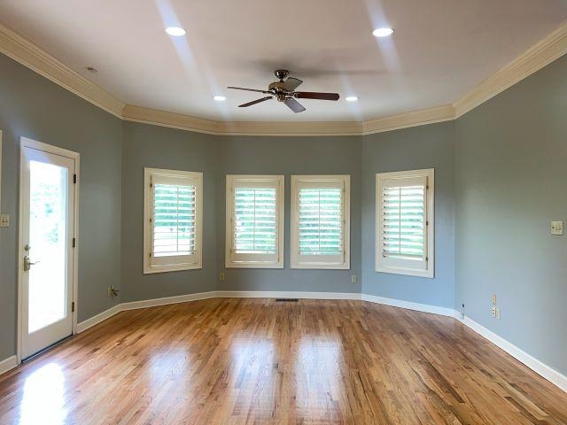 2055 Bobbitt Road Williston, TN 38076 - Photo 10 of 40 Spare room with a ceiling fan, wood finished floors, a healthy amount of sunlight, and ornamental molding