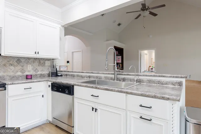 a kitchen with granite countertop a sink and cabinets
