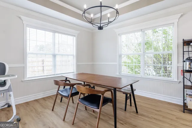 a view of a dining room with furniture window and wooden floor