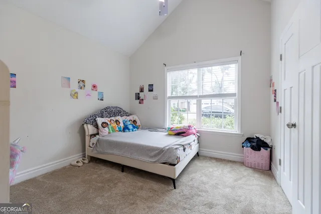 a bedroom with a bed and a window