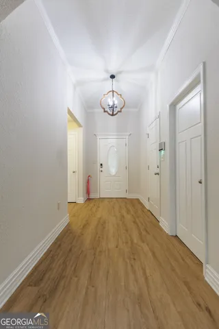 a view of empty room with wooden floor and window