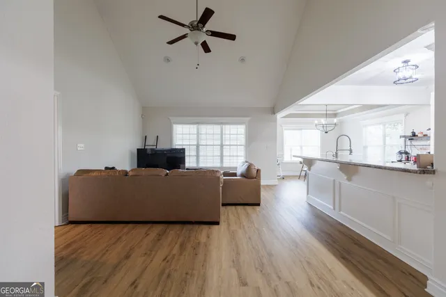 a living room with furniture and a wooden floor