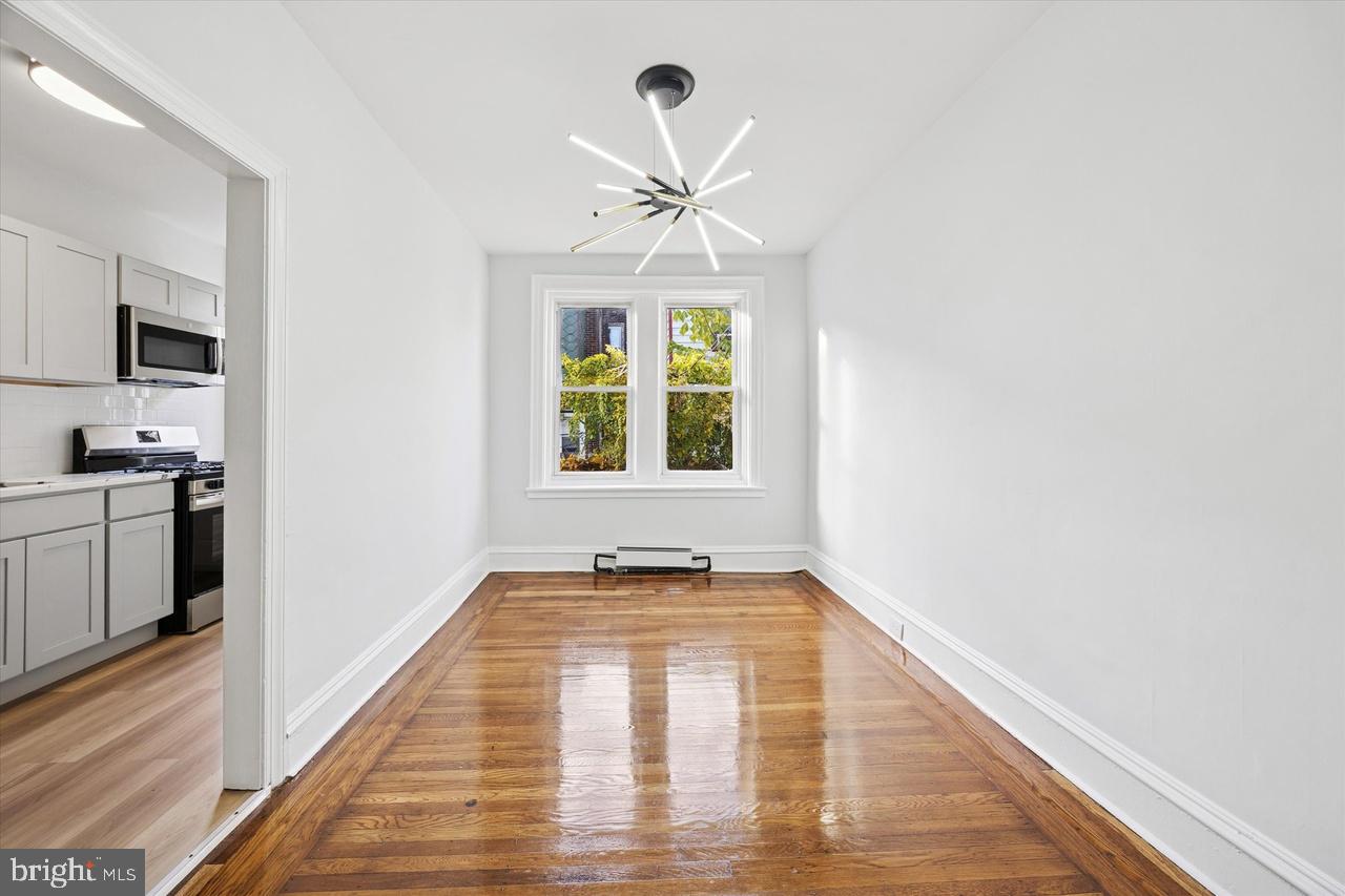 5818 Addison Street Philadelphia, PA 19143 - Photo 3 of 11 a view of empty room with wooden floor and fan