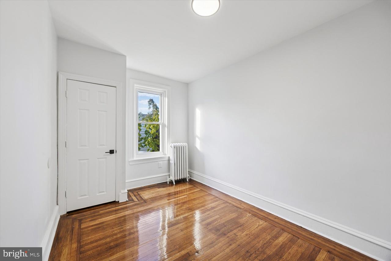 5818 Addison Street Philadelphia, PA 19143 - Photo 8 of 11 a view of room with window and hardwood floor