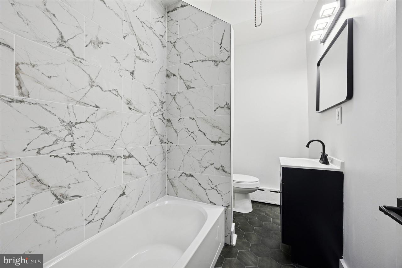 5818 Addison Street Philadelphia, PA 19143 - Photo 9 of 11 a bathroom with a bathtub and a toilet