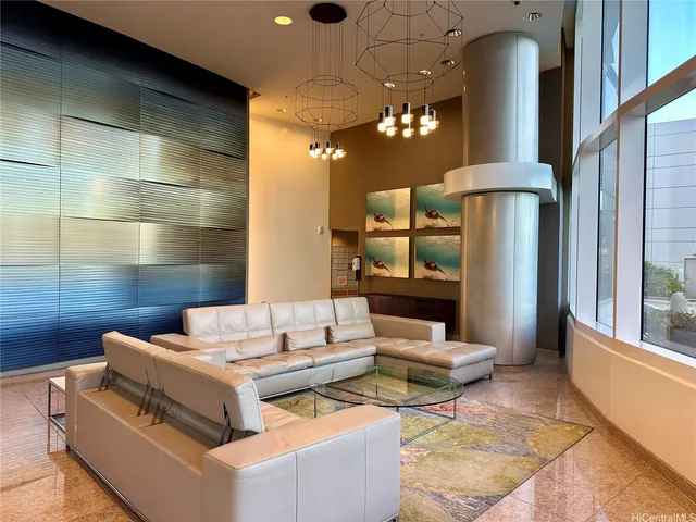 a living room with furniture and a chandelier