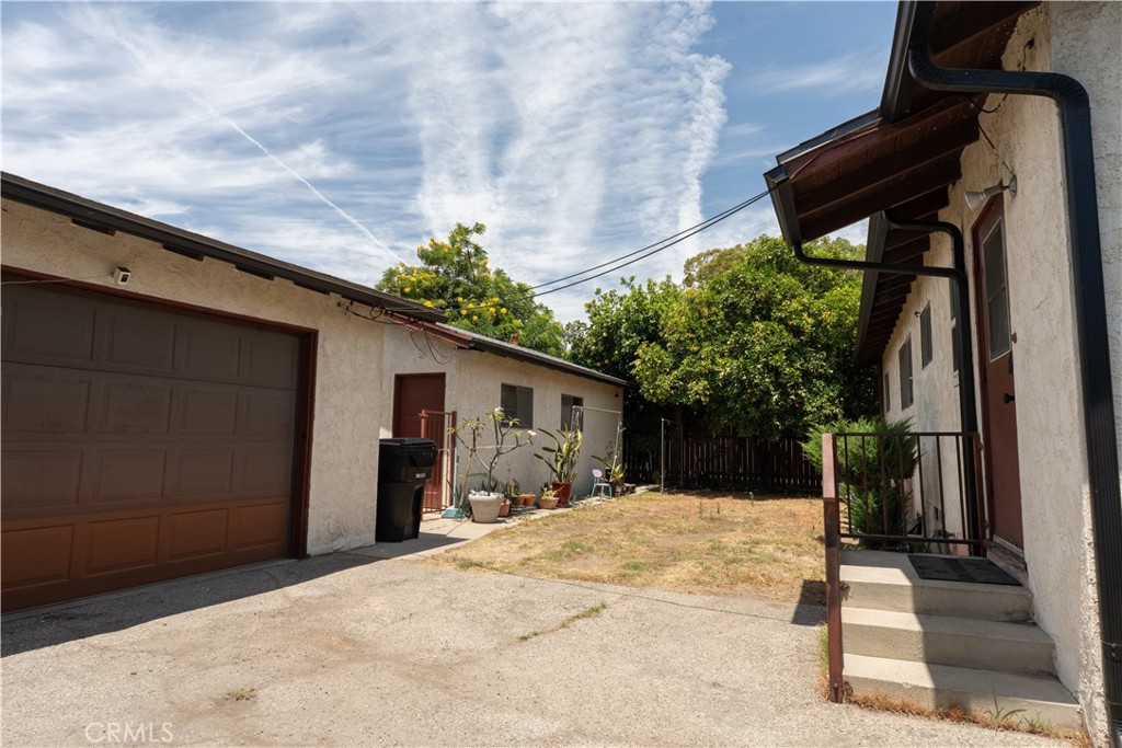 9418 East Duarte Road Arcadia, CA 91007 - Photo 4 of 21 a backyard of a house with a tree and wooden fence