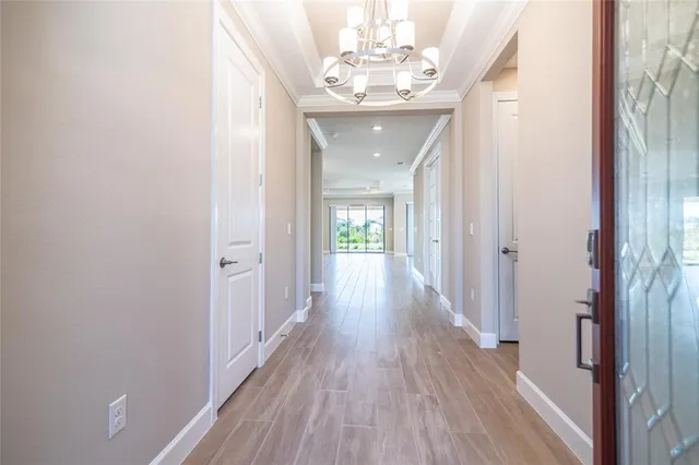 a view of a hallway with wooden floor and closet