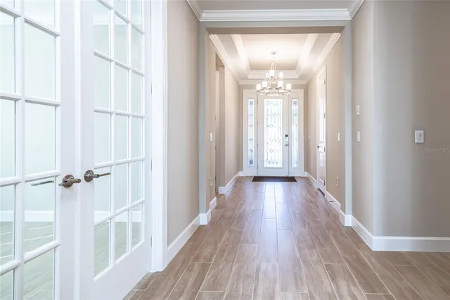 a living room with furniture kitchen view and a large window