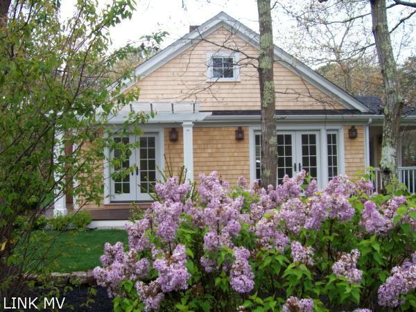 243 Katama Road Edgartown, MA 02539 - Photo 4 of 6 a view of a house with a lot of flower plants