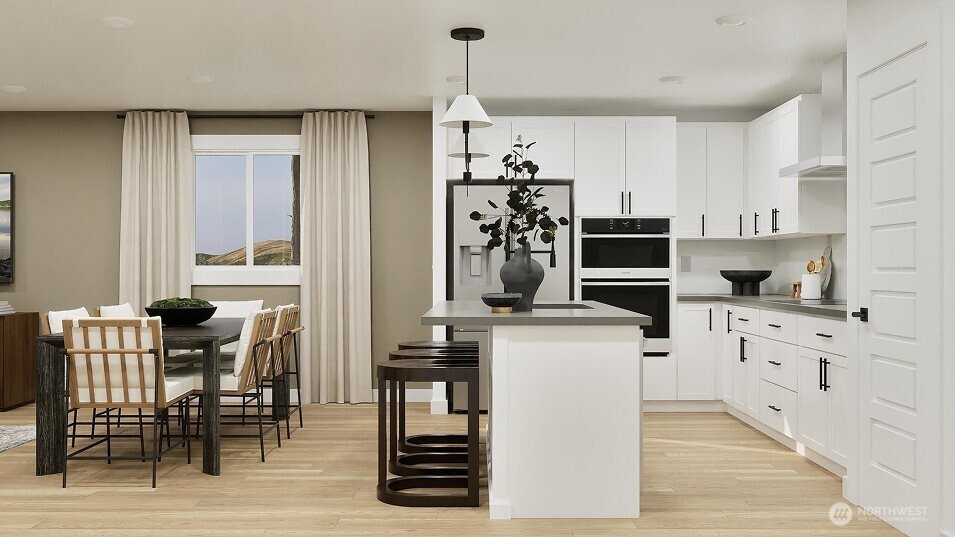 547 Silver Frost Drive Sequim, WA 98382 - Photo 3 of 15 a kitchen with stainless steel appliances kitchen island granite countertop a table chairs and a refrigerator