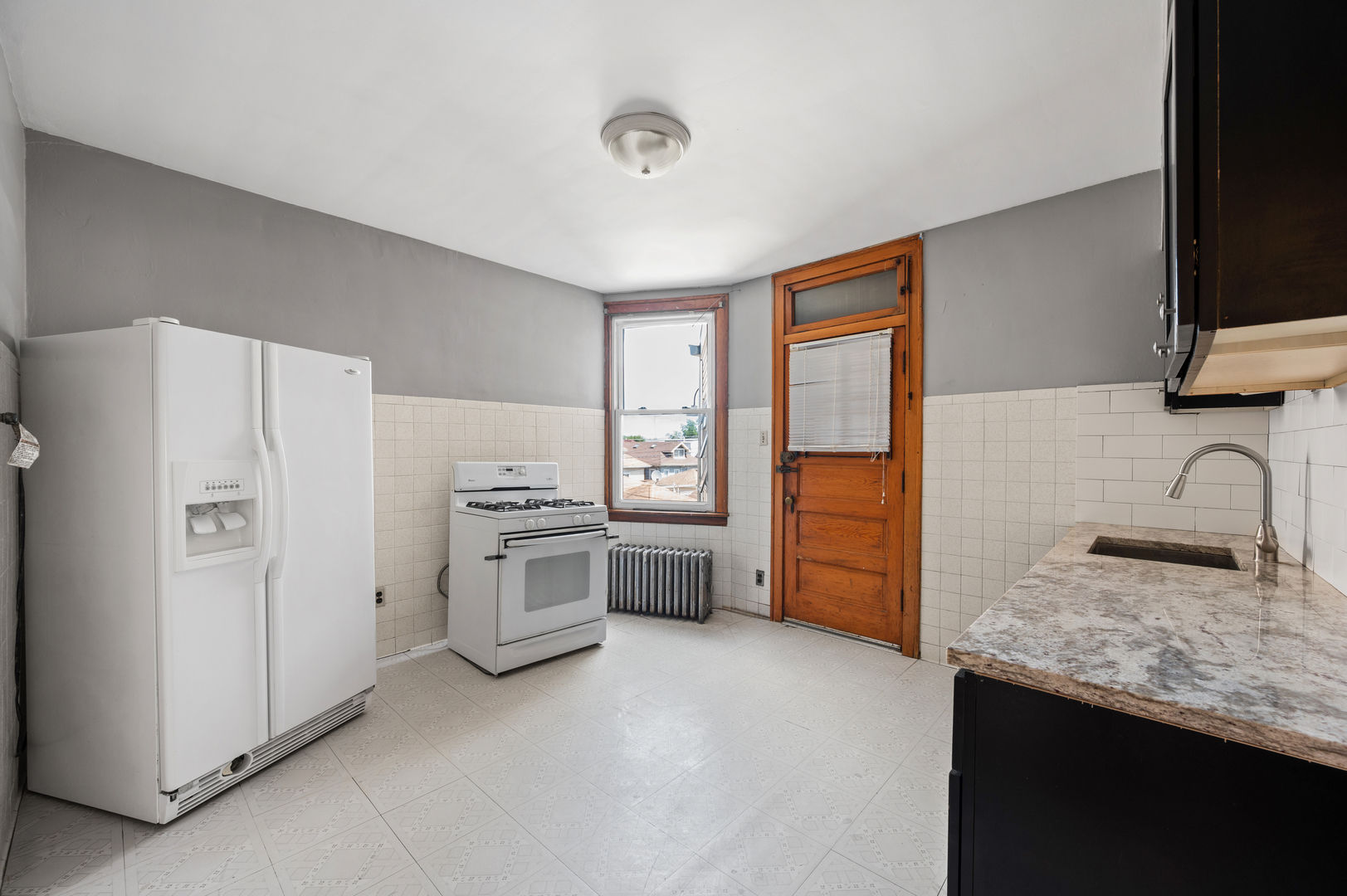 5256 West Wolfram Street, Unit 2 Chicago, IL 60641 - Photo 6 of 11 a kitchen with a refrigerator stove and sink