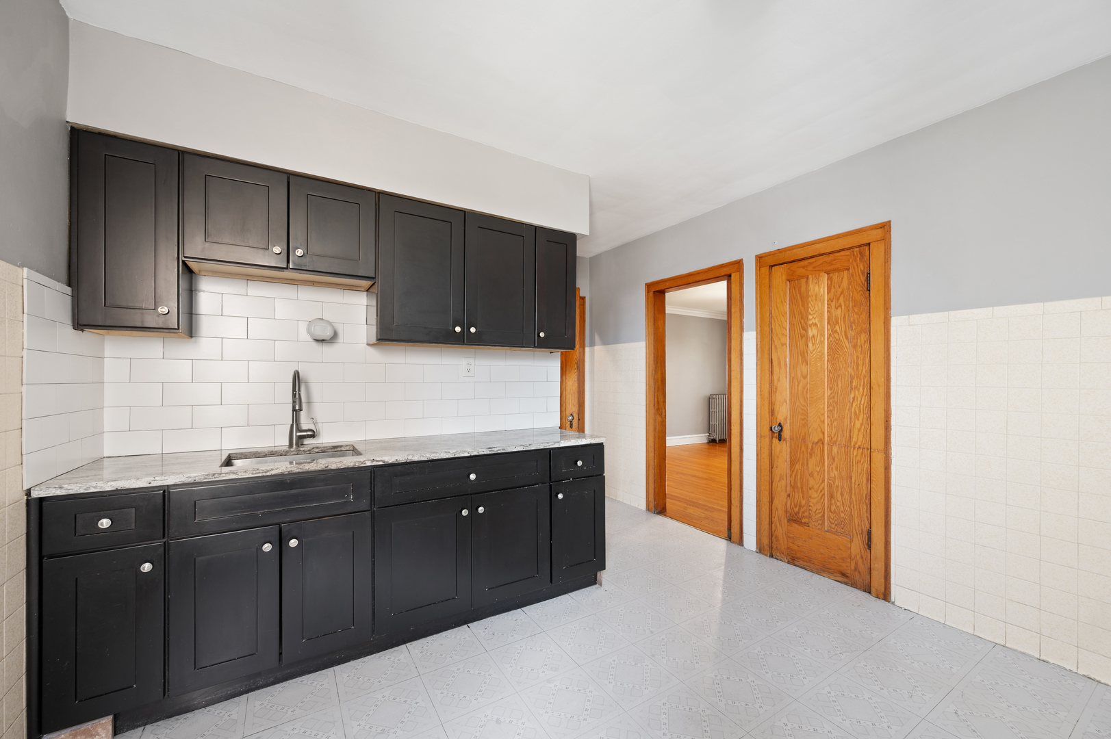 5256 West Wolfram Street, Unit 2 Chicago, IL 60641 - Photo 7 of 11 a kitchen with a sink and cabinets