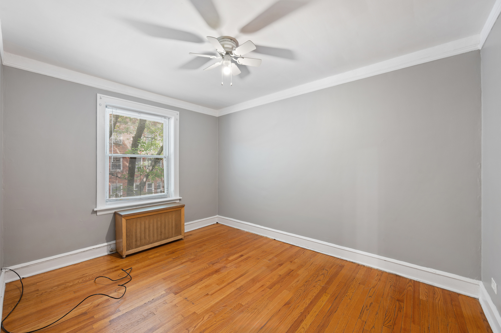 5256 West Wolfram Street, Unit 2 Chicago, IL 60641 - Photo 10 of 11 wooden floor in an empty room with a window