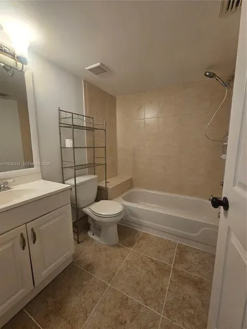 a bathroom with a toilet sink and shower