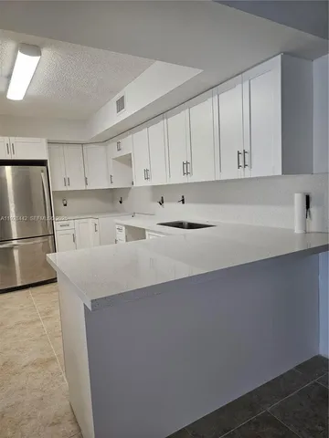 a utility room with cabinets washer and dryer