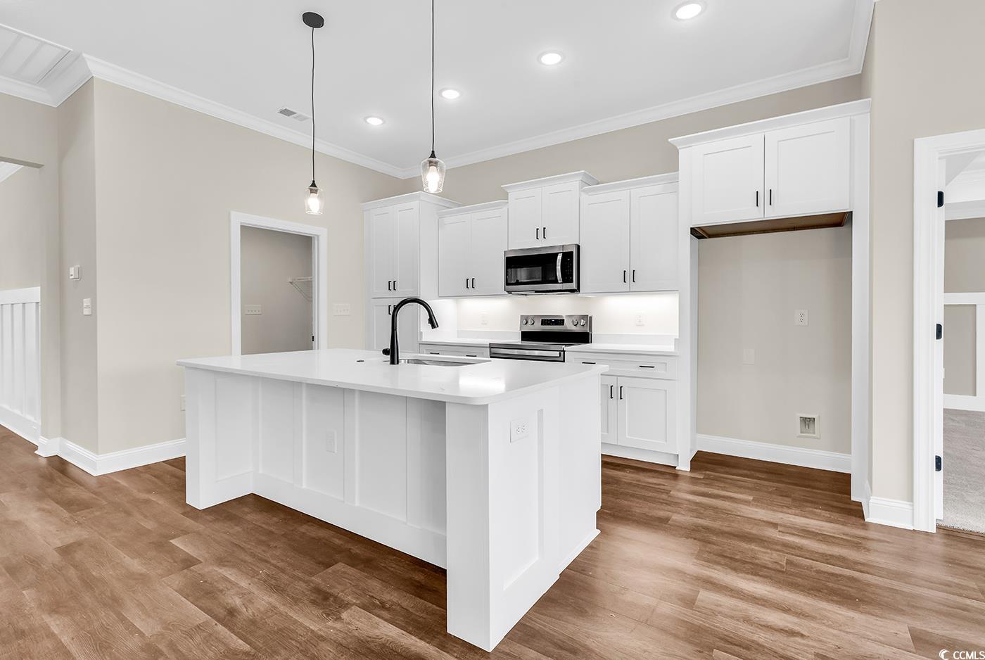 3538 Good Luck Road Aynor, SC 29511 - Photo 13 of 34 Kitchen featuring an island with sink, a sink, sta