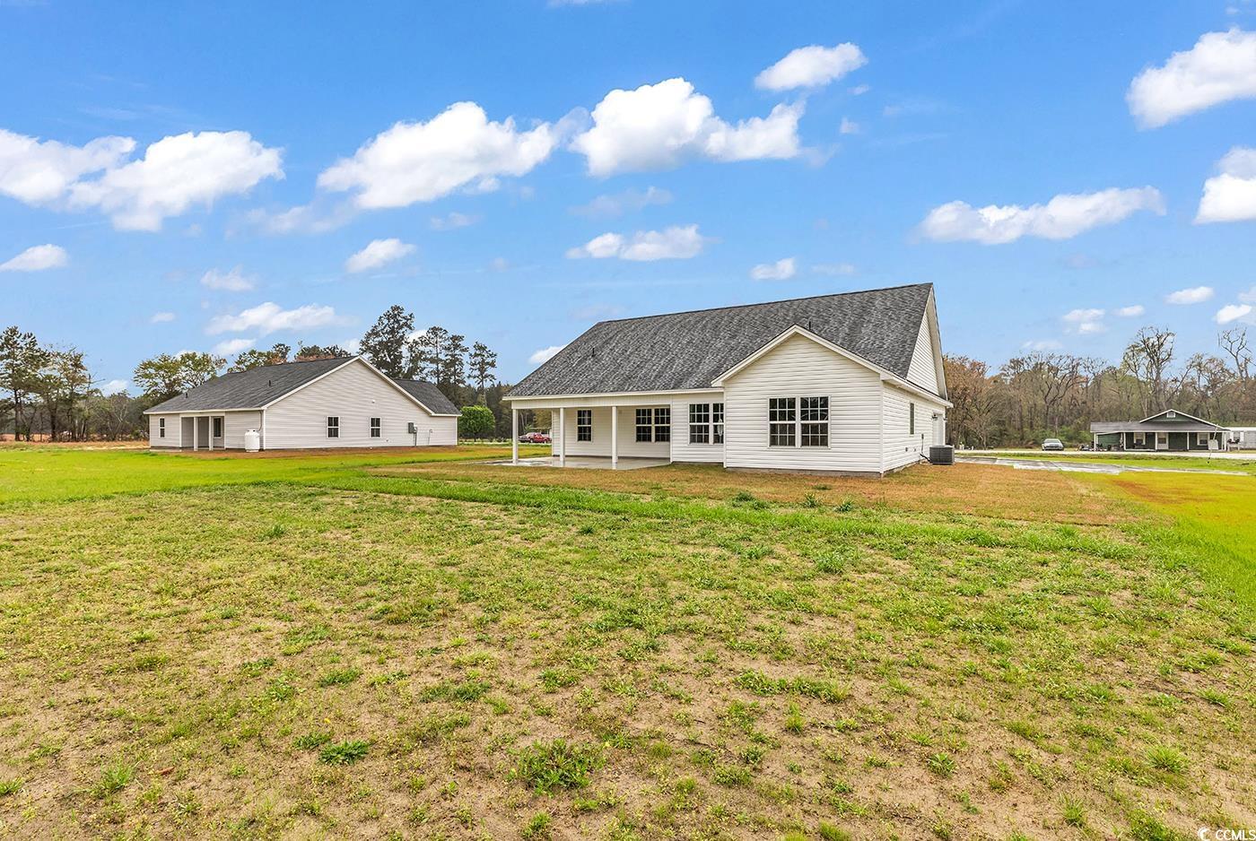 3538 Good Luck Road Aynor, SC 29511 - Photo 4 of 34 Back of house with a lawn, roof with shingles, and