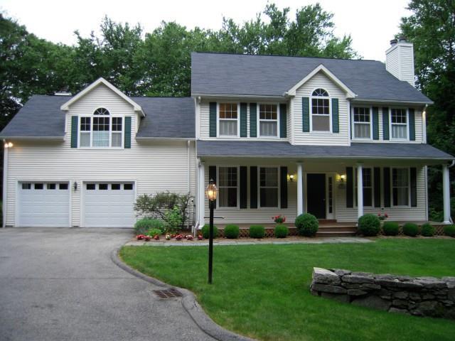 687 Den Road Stamford, CT 06903 - Photo 1 of 1 a front view of a house with a garden and plants