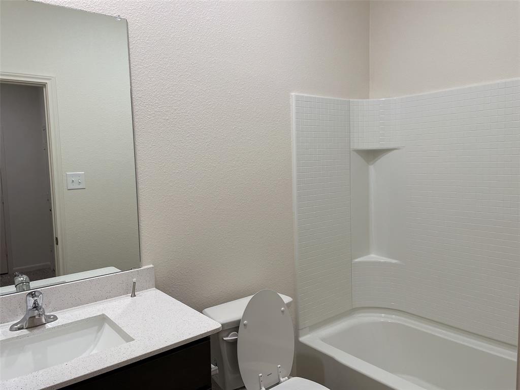 1819 Fergus Ponder, TX 76259 - Photo 7 of 8 a bathroom with a sink a toilet and shower