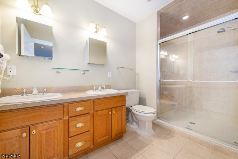 16 Main Street Sparta, NJ 07871 - Photo 18 of 33 a bathroom with a double vanity sink toilet and shower
