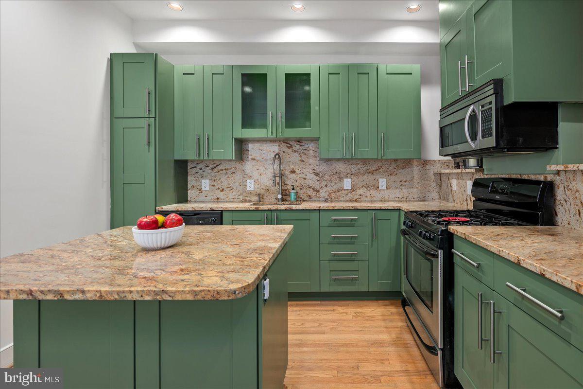 603 P Street Northwest Washington, DC 20001 - Photo 27 of 57 a kitchen with sink a microwave and cabinets