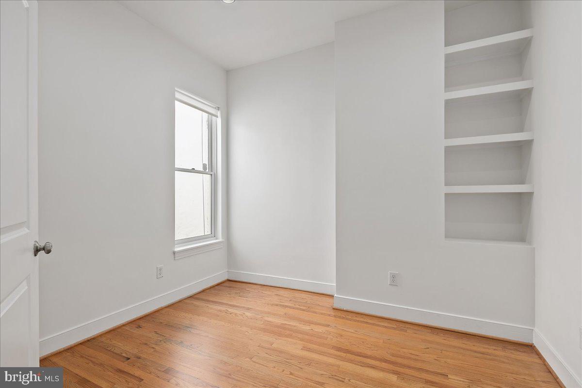 603 P Street Northwest Washington, DC 20001 - Photo 37 of 57 a view of an empty room with a window and wooden floor